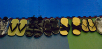 Zori and sandals lined up at the edge of the mat